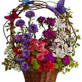 Basket of colorful flowers with butterfly decorations