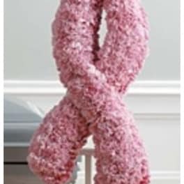 Pink floral ribbon-shaped standing arrangement on an easel