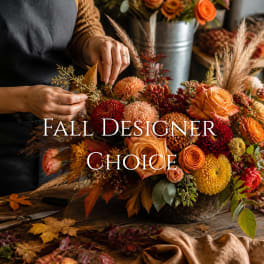 Fall floral arrangement with orange roses and mums on a table