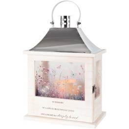 White memorial lantern with a floral scene and candle inside
