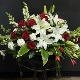 Red roses and white lilies in a low black container