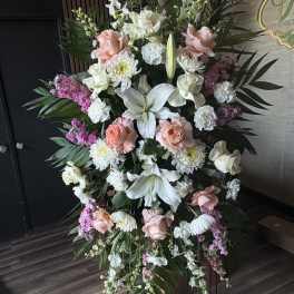 Large standing floral spray with white lilies, pink roses, and white chrysanthemums