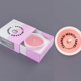 Pink candle in a white tin with matching box packaging