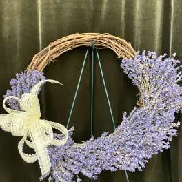Lavender floral wreath on a grapevine ring with a lace bow