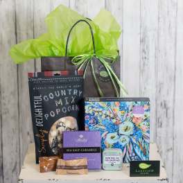 Gift bag with popcorn, candy, puzzle, and small game items