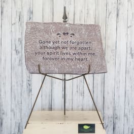 Memorial plaque on a metal stand with a sympathy message