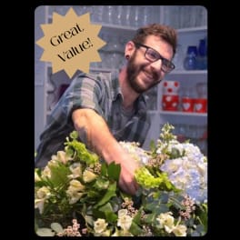 Man arranging a large bouquet with a "Great Value!" badge