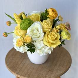 Yellow and white rose bouquet in a white vase