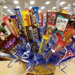 Basket arrangement of assorted candy bars with blue ribbon