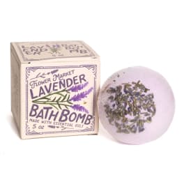 Lavender bath bomb beside its labeled box