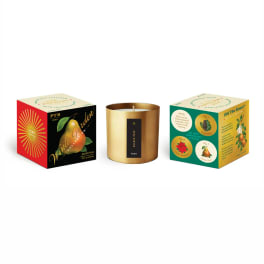 Three boxed candles, including a gold tin candle in the center