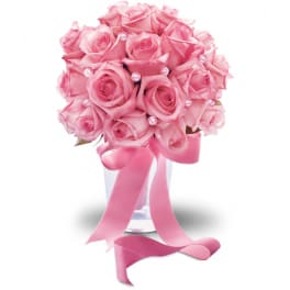 Pink rose bouquet in a clear vase with a satin ribbon