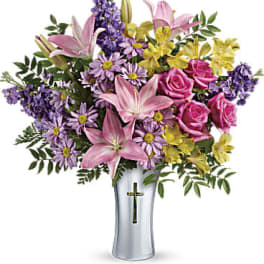 Pink lilies, roses, and purple flowers in a silver vase