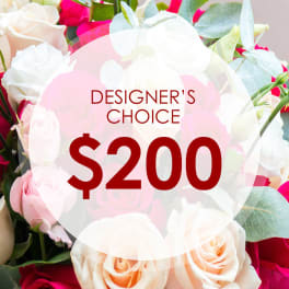 Mixed bouquet of white, pink, and peach roses with a $200 designer's choice label