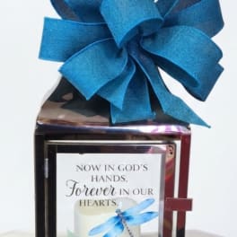 Decorative memorial lantern with a large blue bow and sympathy message