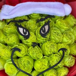 Green rose bouquet styled like the Grinch with a Santa hat