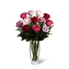 Bouquet of pink, red, and lavender roses in a clear glass vase
