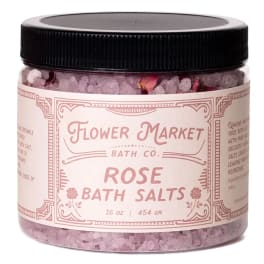 Jar of rose bath salts with a black lid and pink label