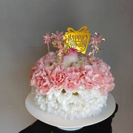 Pink and white flower cake with a happy birthday topper