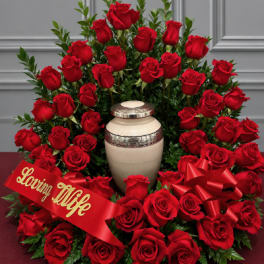 Large red rose arrangement with a memorial urn and ribbon