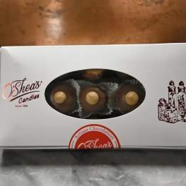 Box of assorted chocolates with a window showing round candies