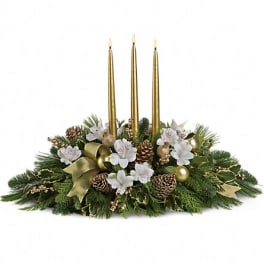 Holiday centerpiece with three gold candles and white flowers