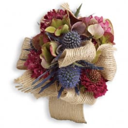 Bouquet of pink and blue flowers wrapped in burlap ribbon