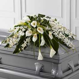 White floral spray on a gray casket