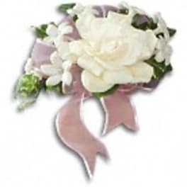 White rose corsage with a pink ribbon
