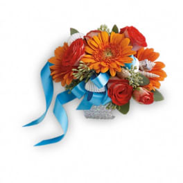 Orange gerbera daisies and red roses with a blue ribbon