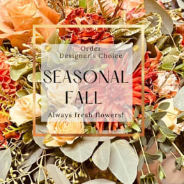Fall bouquet with orange and cream flowers and greenery