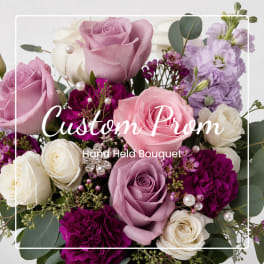Handheld bouquet of pink, lavender, and white roses with purple accents