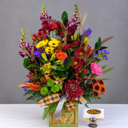 Mixed bouquet in a Halloween-themed box with bright fall flowers
