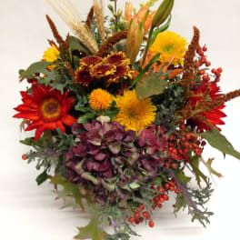 Autumn bouquet with red and yellow flowers and purple hydrangea