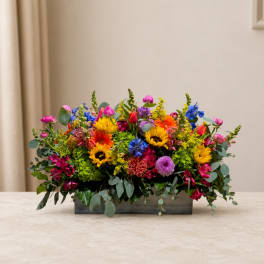 Colorful mixed flower arrangement in a rectangular wooden box