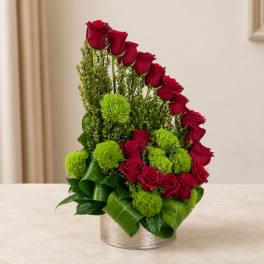 Red roses and green pom-pom flowers in a silver round container