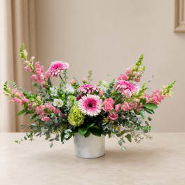 Pink and white mixed flower arrangement in a white vase