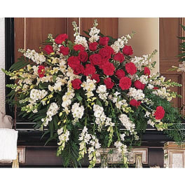 Large red and white floral arrangement with roses and cascading blooms