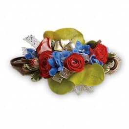 Low floral arrangement with red roses and blue flowers
