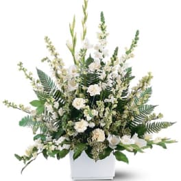 White floral arrangement in a white rectangular container