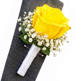 Yellow rose boutonniere with white baby's breath and a white ribbon wrap