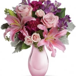 Pink and purple bouquet in a pink glass vase