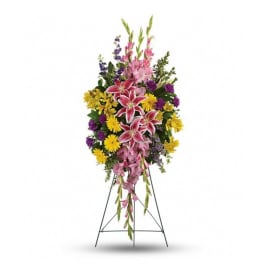 Tall standing floral spray with pink lilies, yellow daisies, and purple flowers