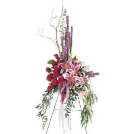 Tall standing floral spray with pink lilies and red roses