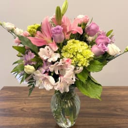 Pink and lavender mixed bouquet in a clear glass vase