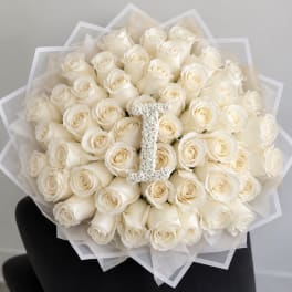 Bouquet of white roses with a jeweled letter I centerpiece