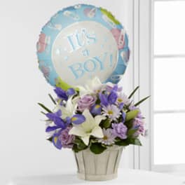Bouquet of purple and white flowers with a "It's a Boy!" balloon