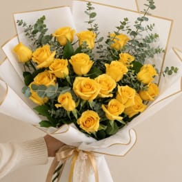 Bouquet of yellow roses with eucalyptus in white wrap