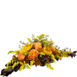 Orange roses and yellow flowers arranged in a low centerpiece
