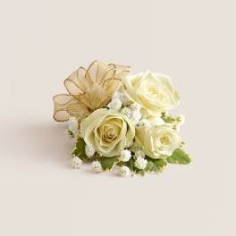 Small cream rose arrangement with gold ribbon and white filler flowers